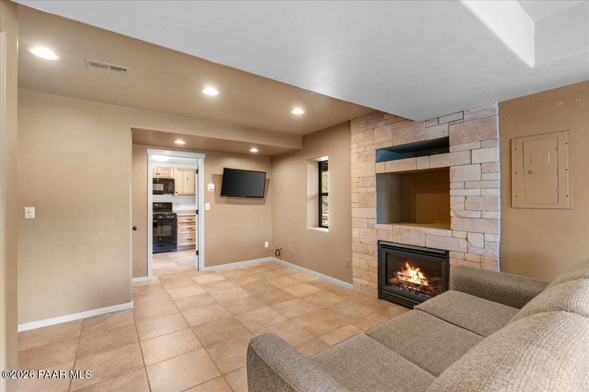 646 South Rancho Vista Drive Prescott, AZ 86303 - Photo 31 of 50 a living room with furniture a flat screen tv and a fireplace