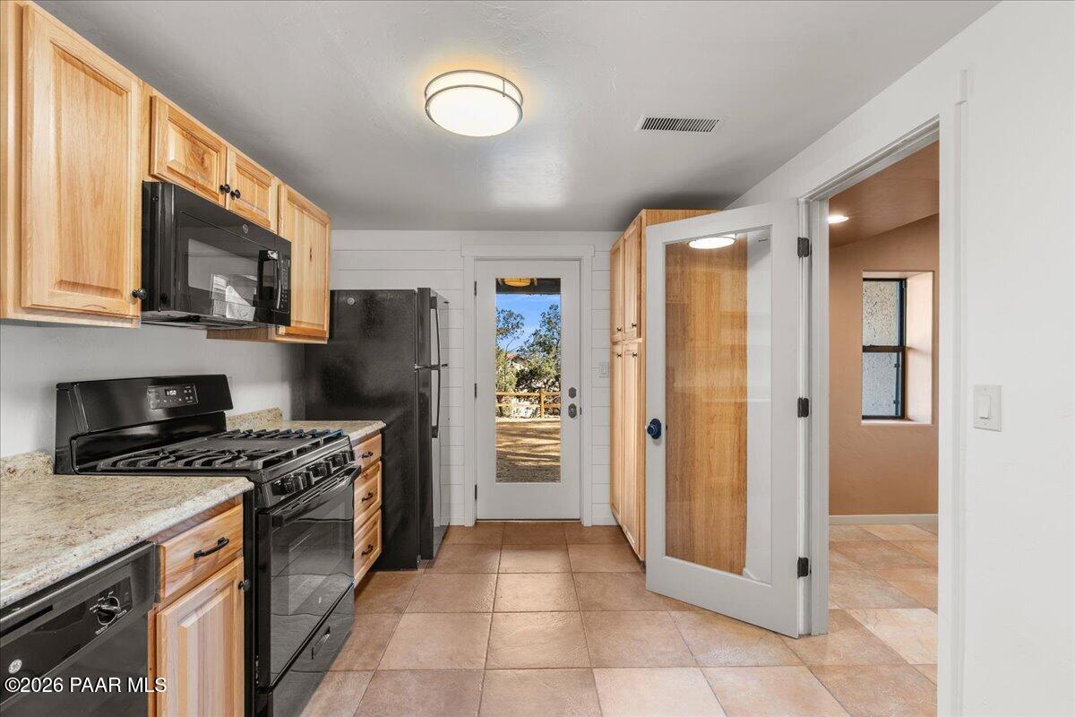 646 South Rancho Vista Drive Prescott, AZ 86303 - Photo 35 of 50 a kitchen with stainless steel appliances granite countertop a stove top oven a sink dishwasher a refrigerator and a microwave