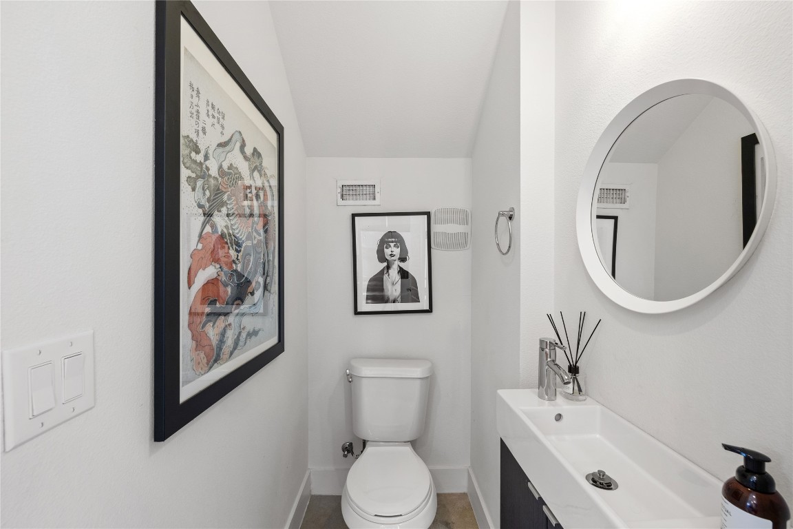 1904 East 17th Street, Unit B Austin, TX 78702 - Photo 12 of 34 a bathroom with a toilet a sink and mirror