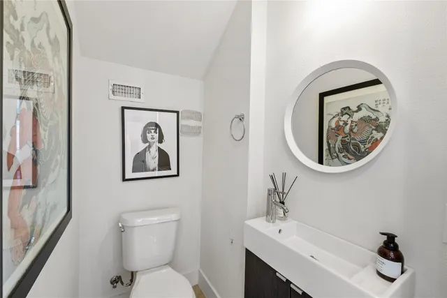 a bathroom with a toilet a sink and a mirror