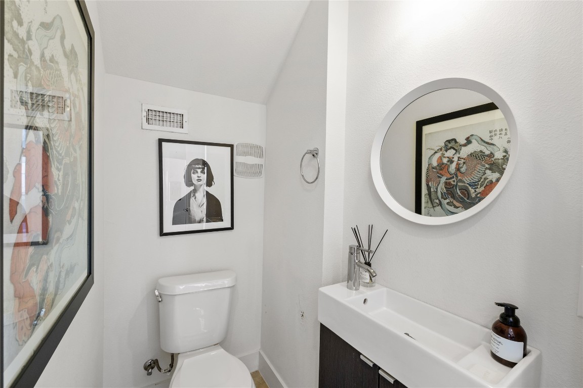 1904 East 17th Street, Unit B Austin, TX 78702 - Photo 13 of 34 a bathroom with a toilet a sink and a mirror