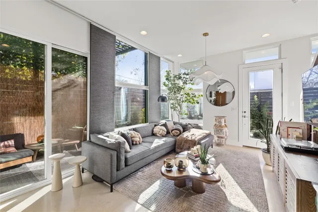 a living room with furniture fireplace and a large window