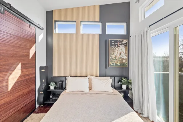 a bed room with a bed and glass door