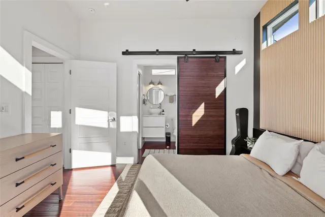 a bedroom with a bed and wooden floor