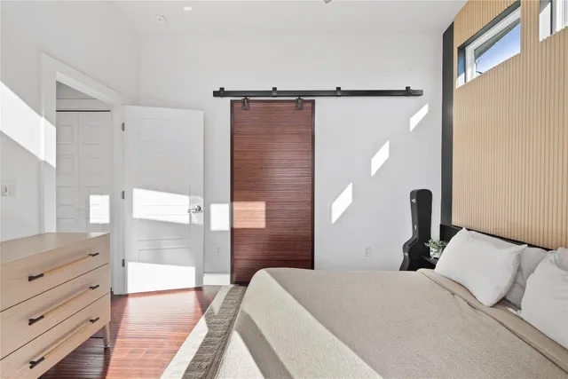 a bedroom with a bed and a mirror