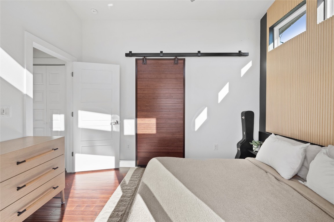 1904 East 17th Street, Unit B Austin, TX 78702 - Photo 22 of 34 a bedroom with a bed and a mirror