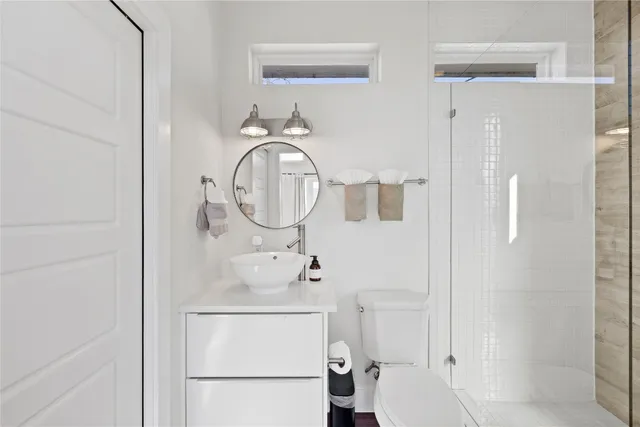 a bathroom with a sink a mirror and shower