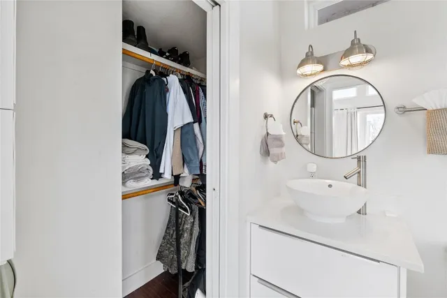 a bathroom with a sink mirror and toilet