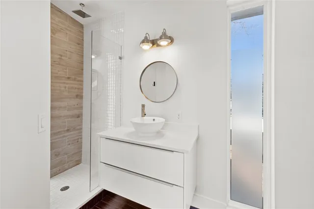 a bathroom with a sink vanity and a mirror