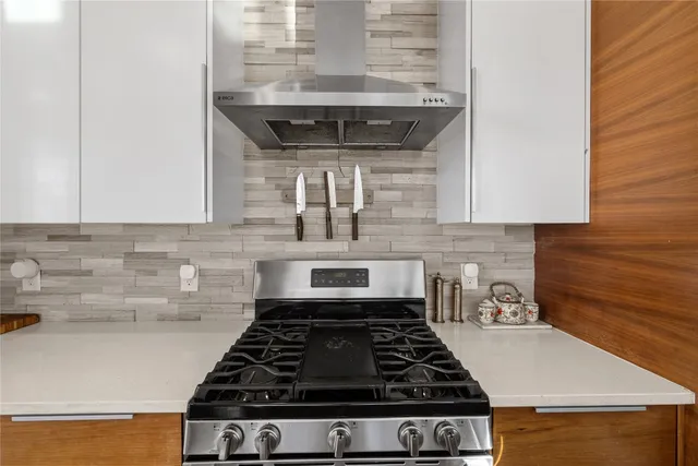 a close view of a stove a microwave and cabinets