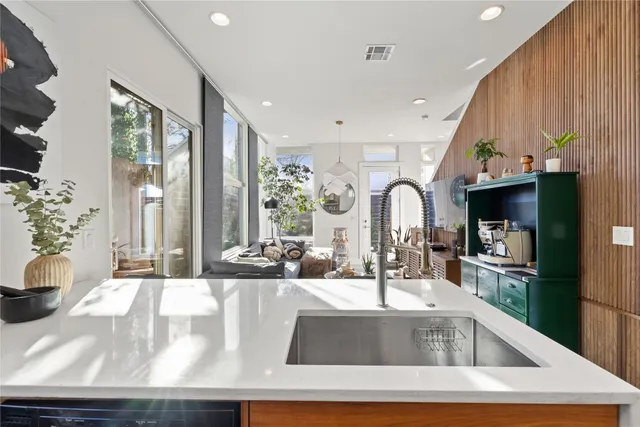 a view of kitchen with sink and refrigerator