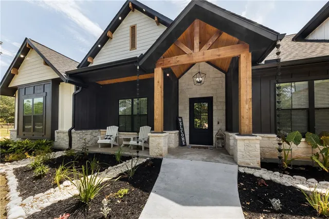 a front view of a house with outdoor seating and a potted plant
