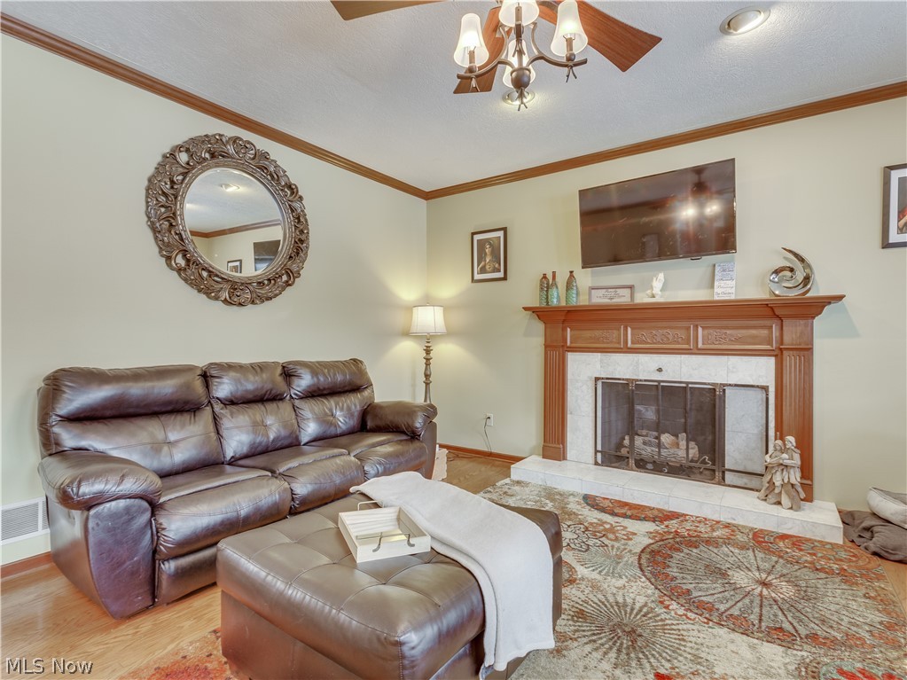 1794 Summerchase Road Northeast Canton, OH 44721 - Photo 16 of 32 Large living room with ceiling fan and wood floors opens to the eat in kitchen