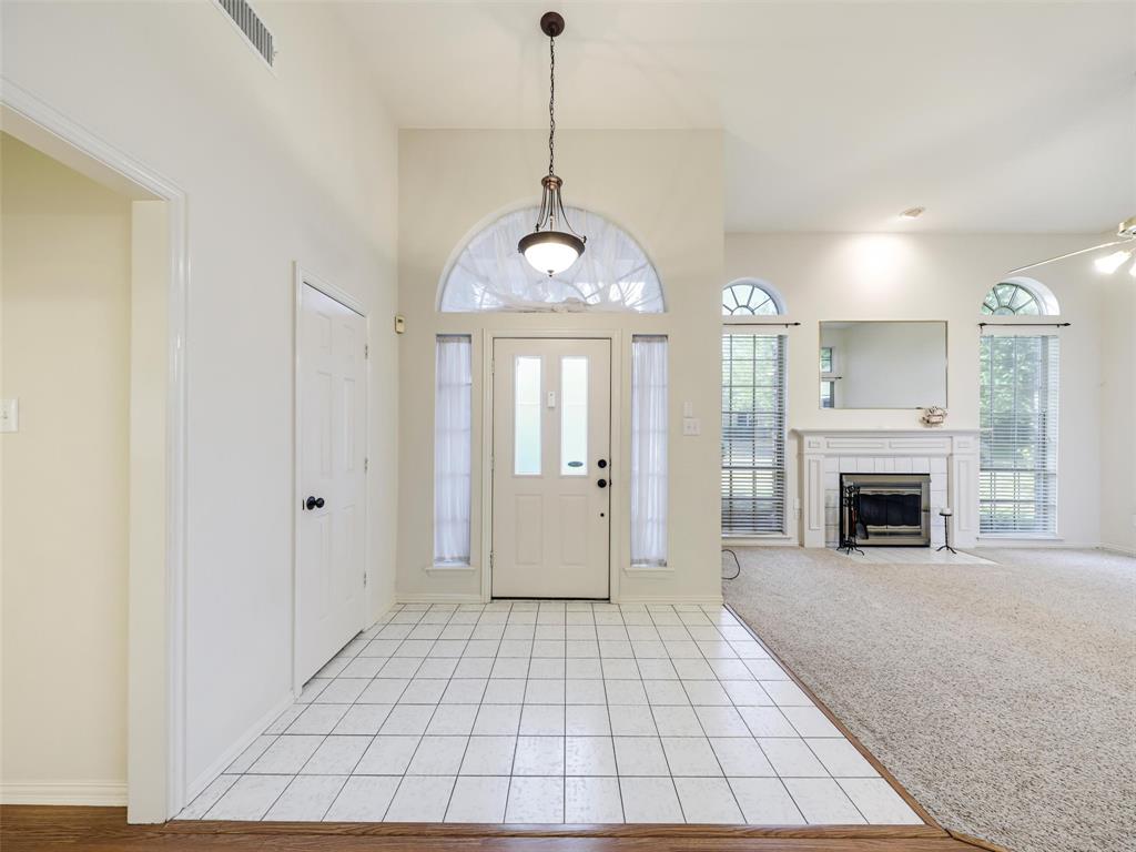 7836 Tournament Road Frisco, TX 75035 - Photo 2 of 23 Entry with white tile flooring and vaulted ceilings