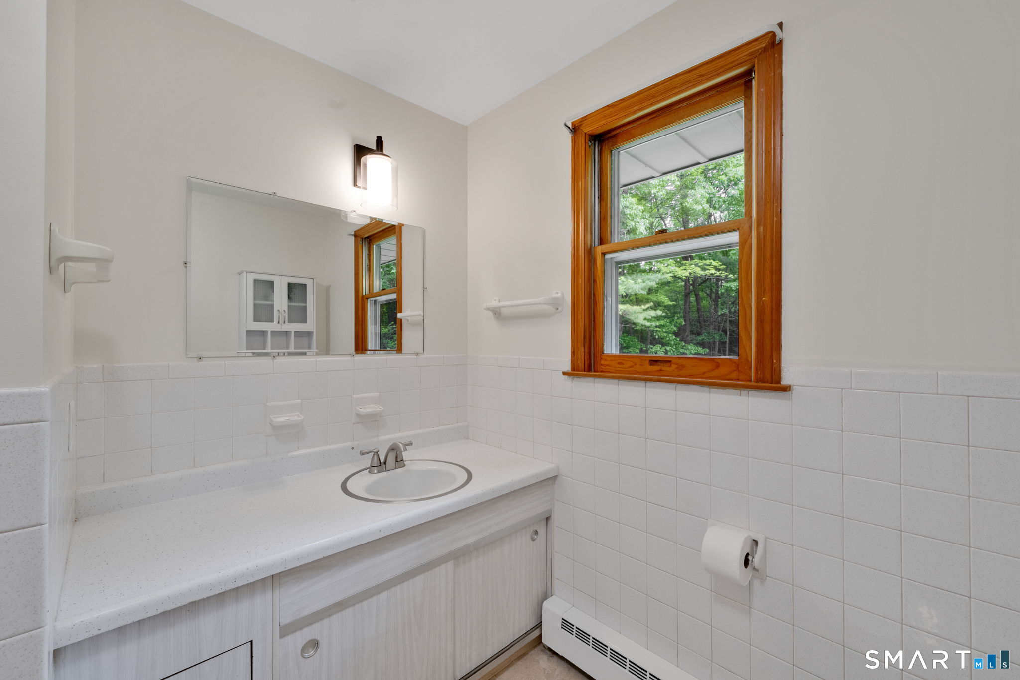 158 Notch Road Granby, CT 06035 - Photo 17 of 40 a bathroom with a sink a mirror and a window