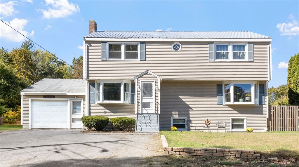229 Washington Terrace Whitman, MA 02382 - Photo 1 of 30 a front view of a house with a yard and garage