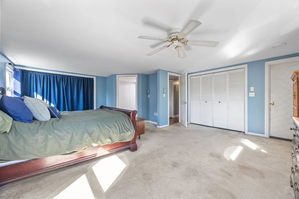 229 Washington Terrace Whitman, MA 02382 - Photo 17 of 30 a bed sitting in a spacious bedroom next to a window