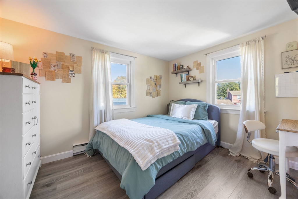 229 Washington Terrace Whitman, MA 02382 - Photo 20 of 30 a large bedroom with a bed and wooden floor