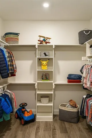 a view of walk in closet with clothes and shoes