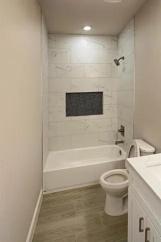 a bathroom with a toilet and a bathtub