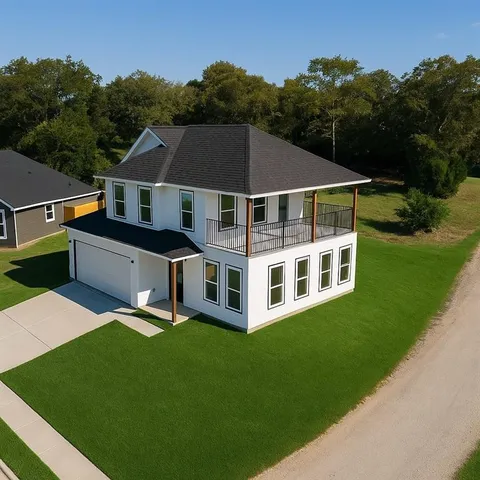 a aerial view of a house with yard and trees in the background