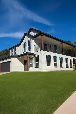a front view of a house with a garden