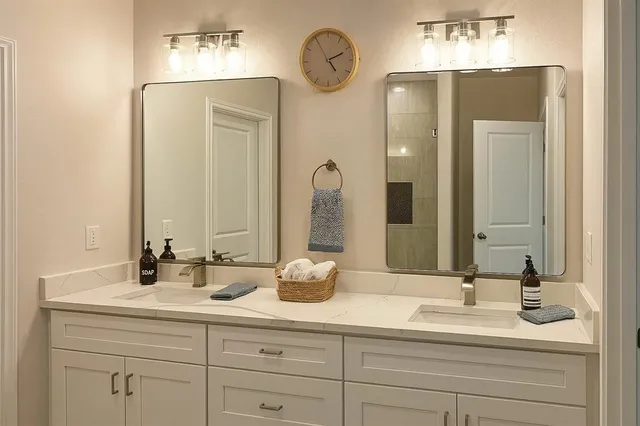 a bathroom with a double vanity sink and a mirror