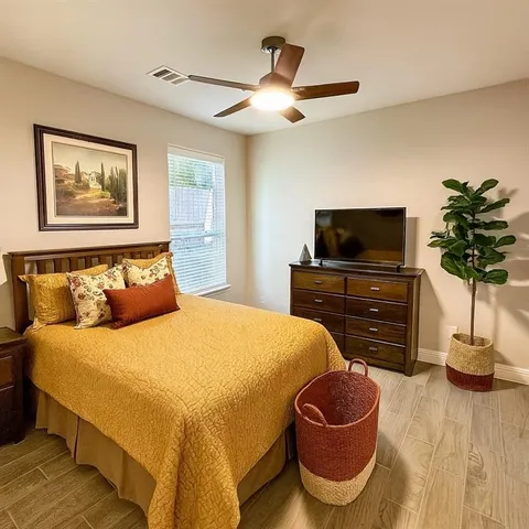 a bedroom with a bed and wooden floor