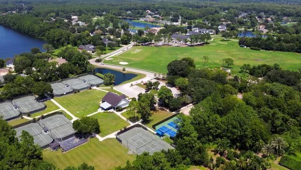 an aerial view of a house with a garden and swimming pool