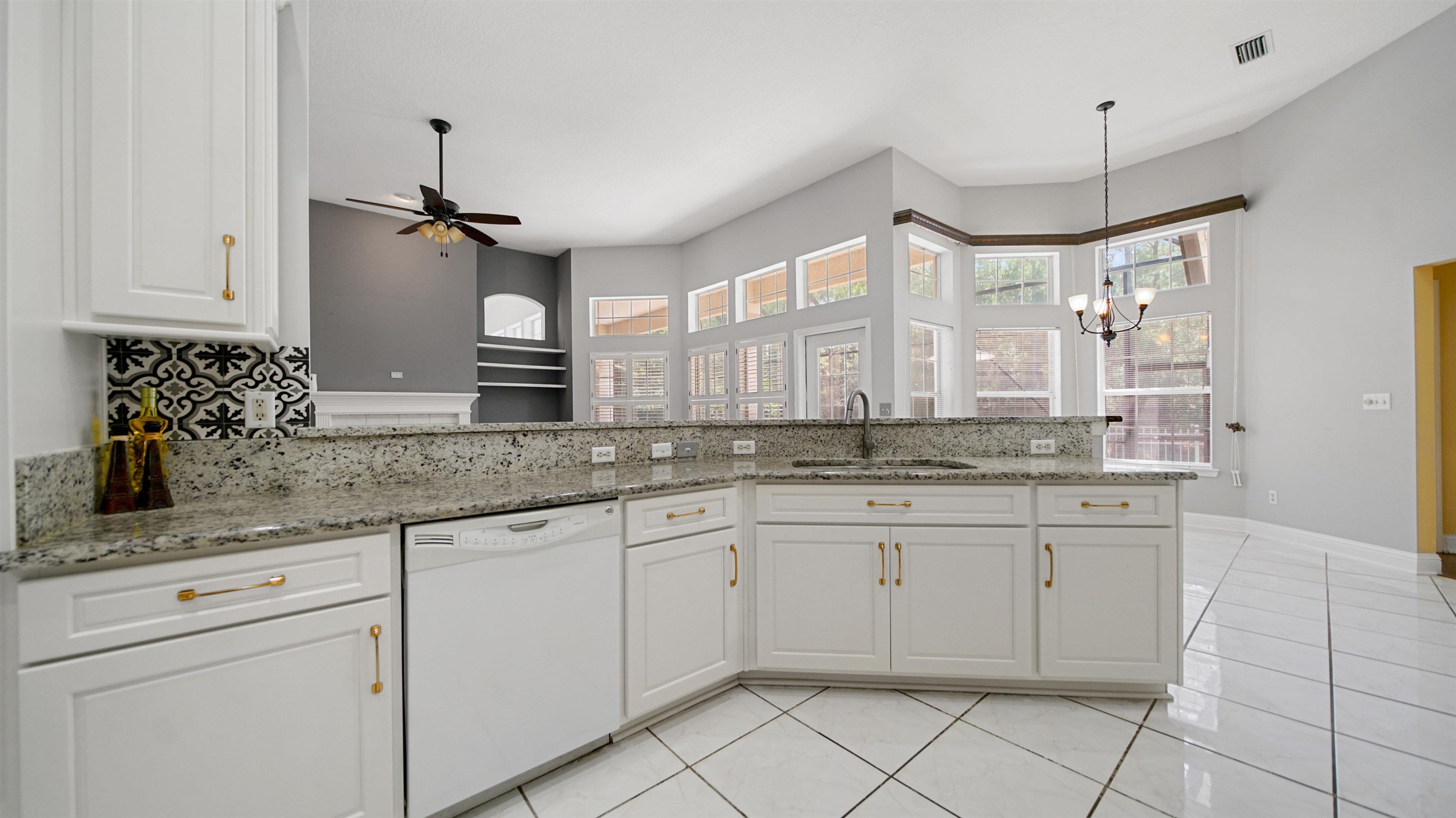 7849 Rittenhouse Lane Jacksonville, FL 32256 - Photo 19 of 50 a bathroom with a granite countertop sink a mirror and a shower