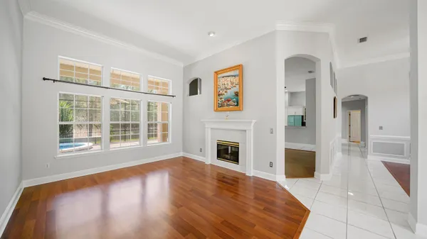 a view of empty room with fireplace and wooden floor