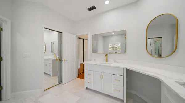 a spacious bathroom with a double vanity sink and a mirror