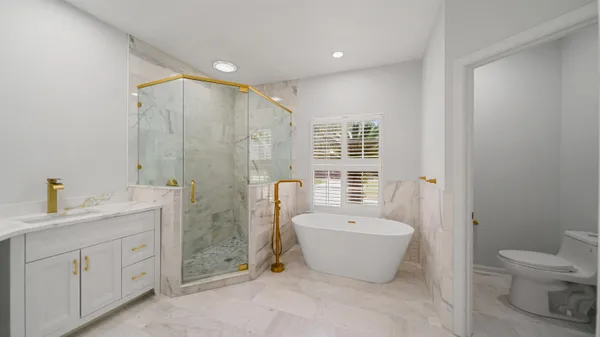 a spacious bathroom with a toilet sink and shower