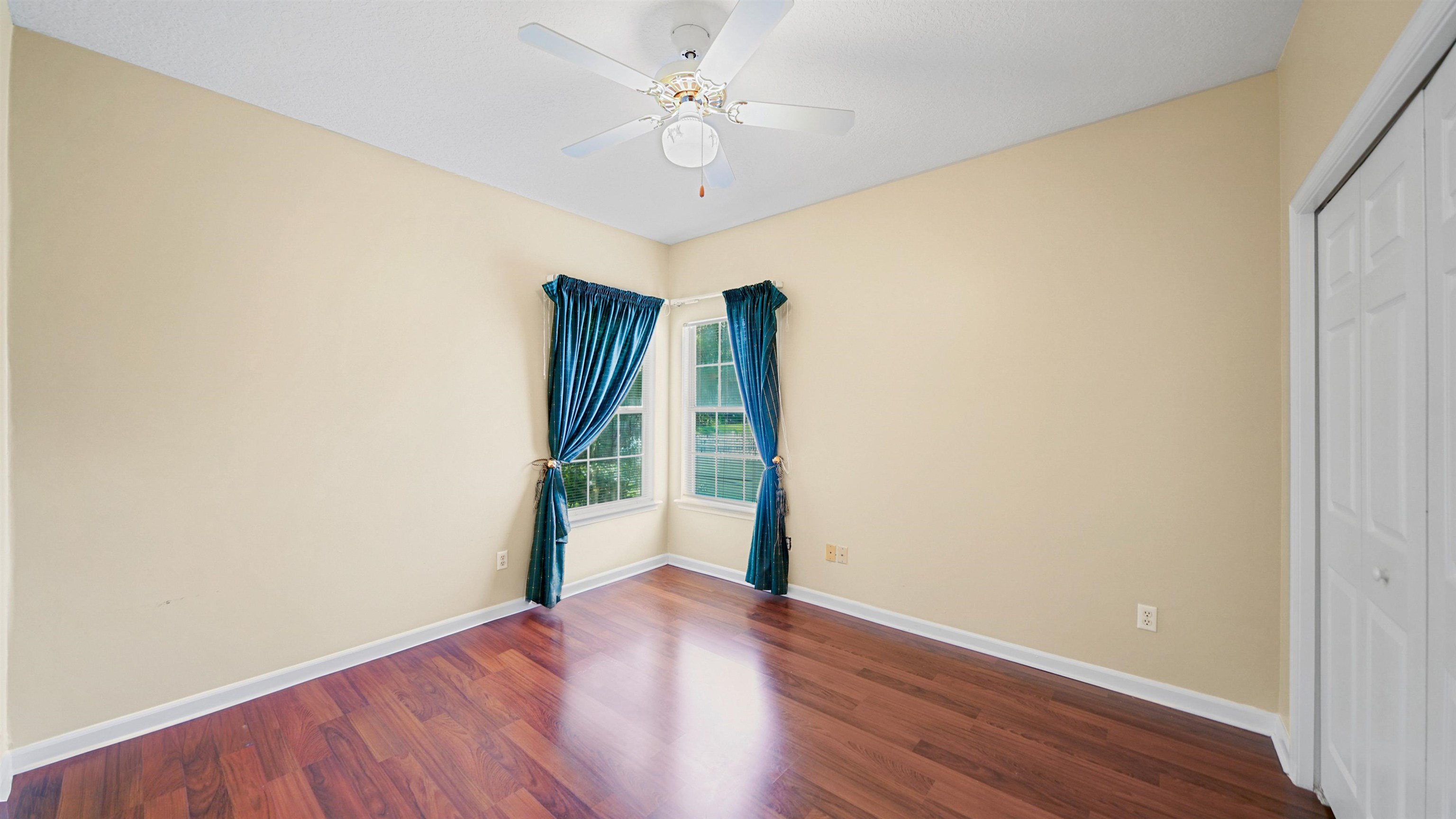 7849 Rittenhouse Lane Jacksonville, FL 32256 - Photo 23 of 50 an empty room with wooden floor and a ceiling fan