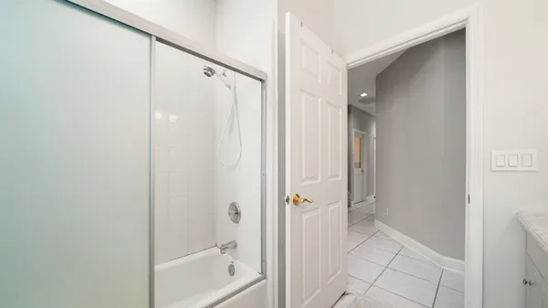 a bathroom with a shower and a glass door