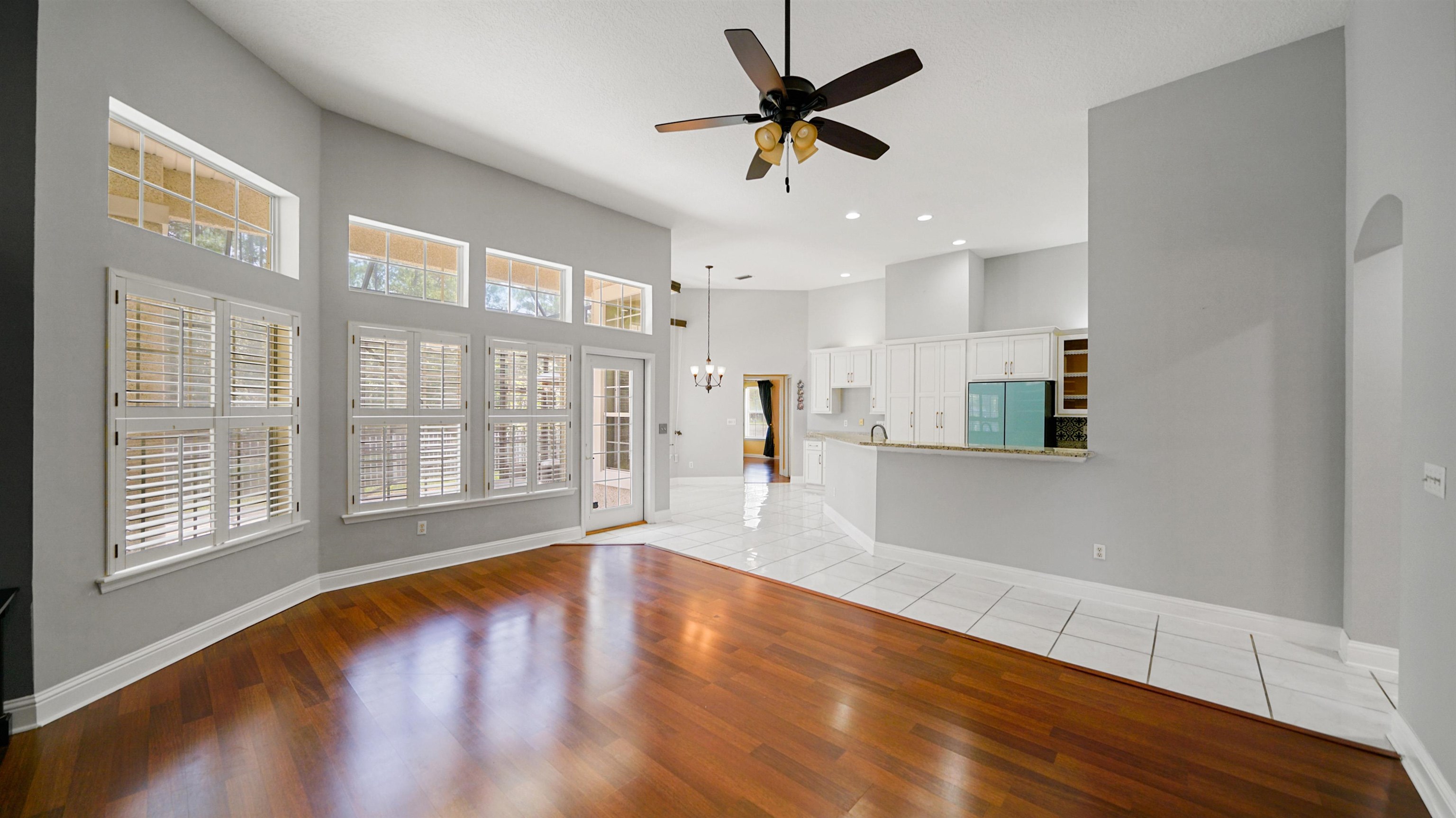 7849 Rittenhouse Lane Jacksonville, FL 32256 - Photo 4 of 50 a view of an empty room with a window and wooden floor
