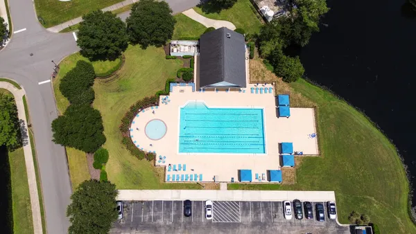 an aerial view of a house with table and chairs