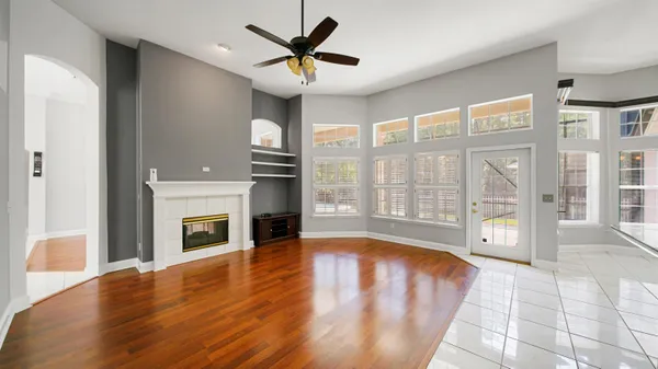 a view of an empty room with a fireplace and a window