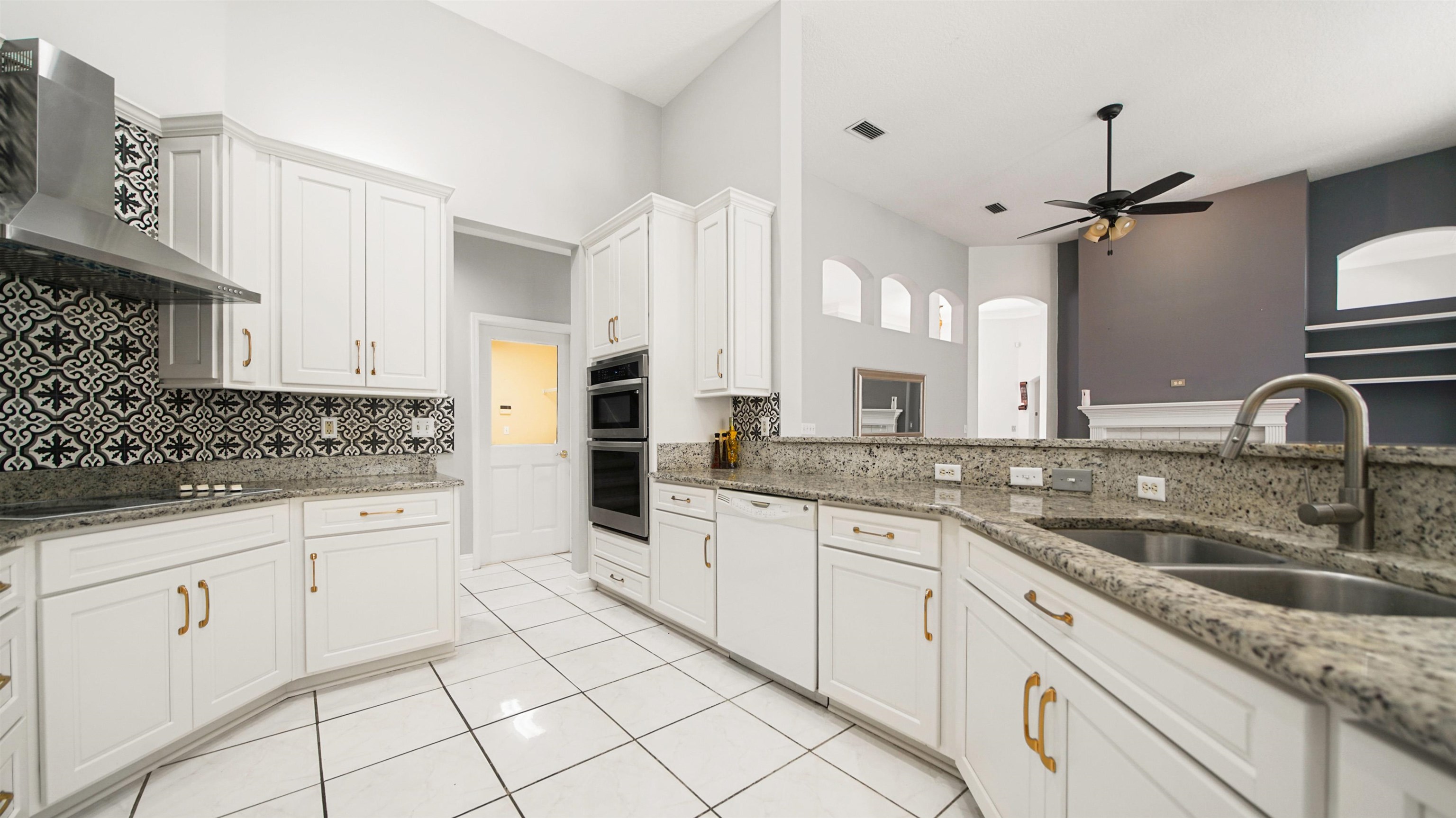 7849 Rittenhouse Lane Jacksonville, FL 32256 - Photo 7 of 50 a kitchen with granite countertop white cabinets white appliances and sink