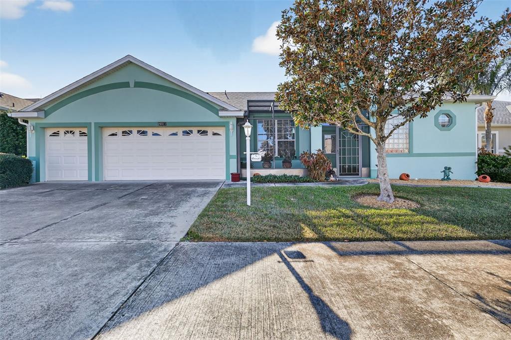 25517 Laurel Valley Road Leesburg, FL 34748 - Photo 2 of 56 a front view of a house with a yard and garage