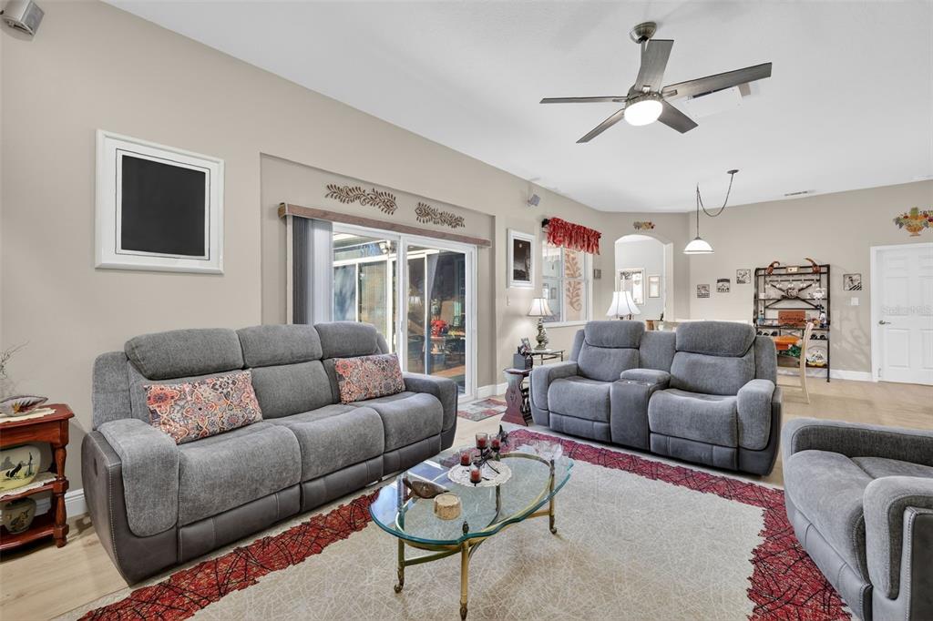 25517 Laurel Valley Road Leesburg, FL 34748 - Photo 22 of 56 a living room with furniture ceiling fan and a rug