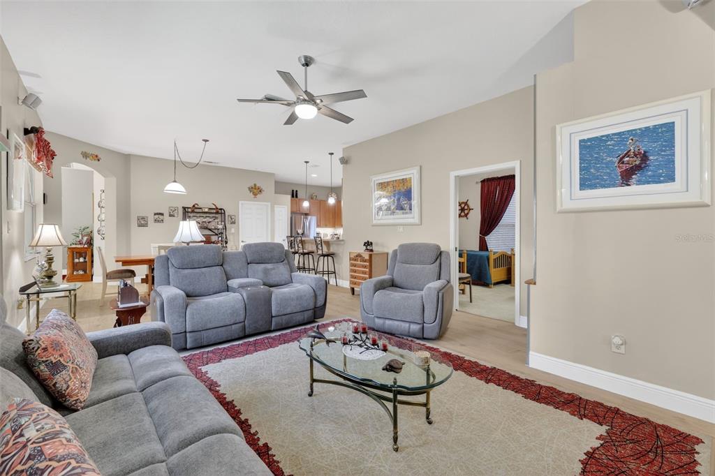 25517 Laurel Valley Road Leesburg, FL 34748 - Photo 23 of 56 a living room with furniture and a view of kitchen