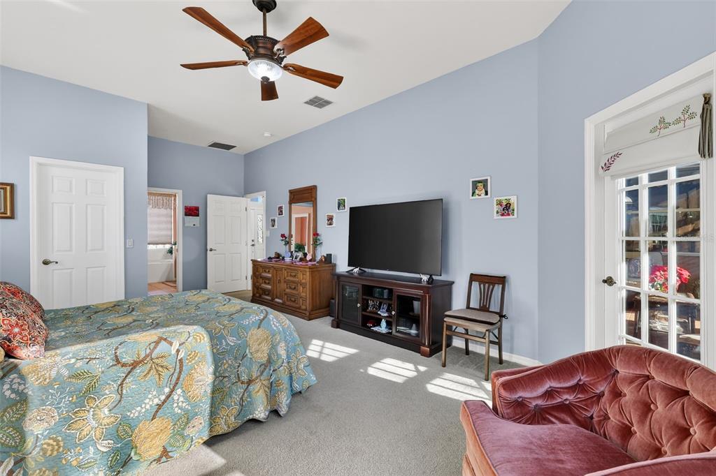 25517 Laurel Valley Road Leesburg, FL 34748 - Photo 26 of 56 a bedroom with a bed and a flat screen tv