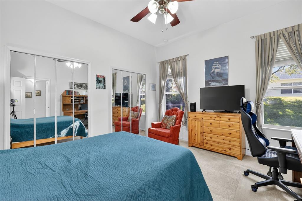 25517 Laurel Valley Road Leesburg, FL 34748 - Photo 31 of 56 a bedroom with a bed and wooden floor