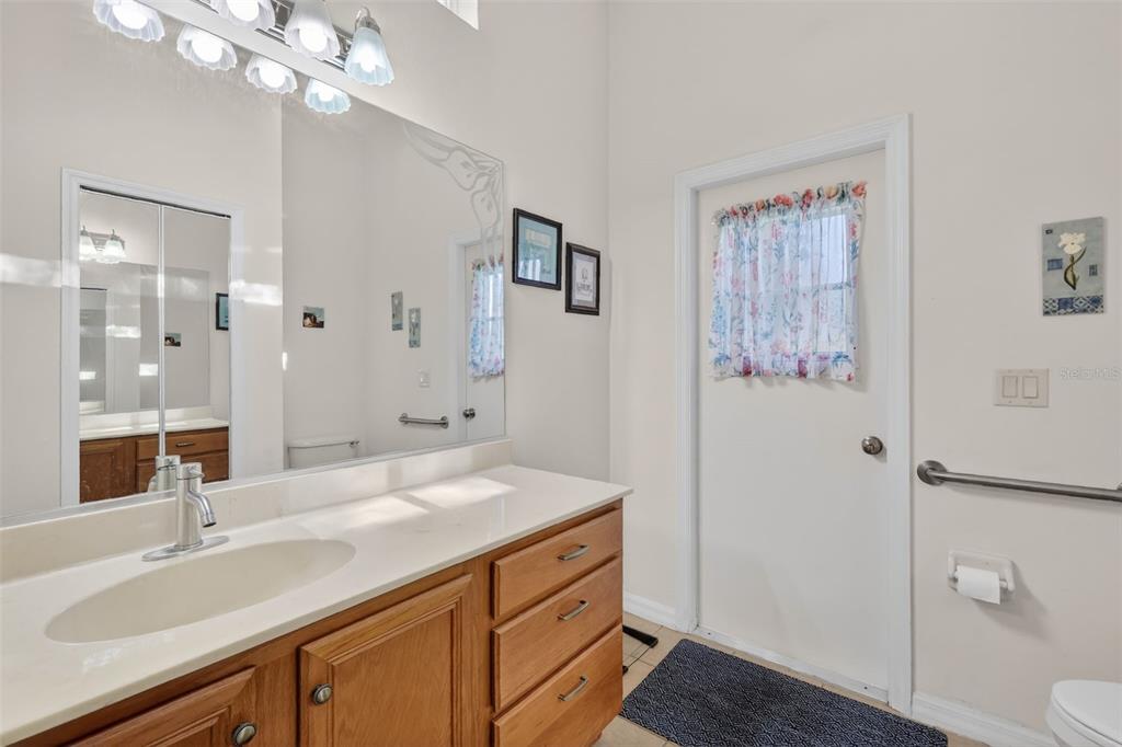 25517 Laurel Valley Road Leesburg, FL 34748 - Photo 33 of 56 a bathroom with a sink a toilet a shower and a mirror