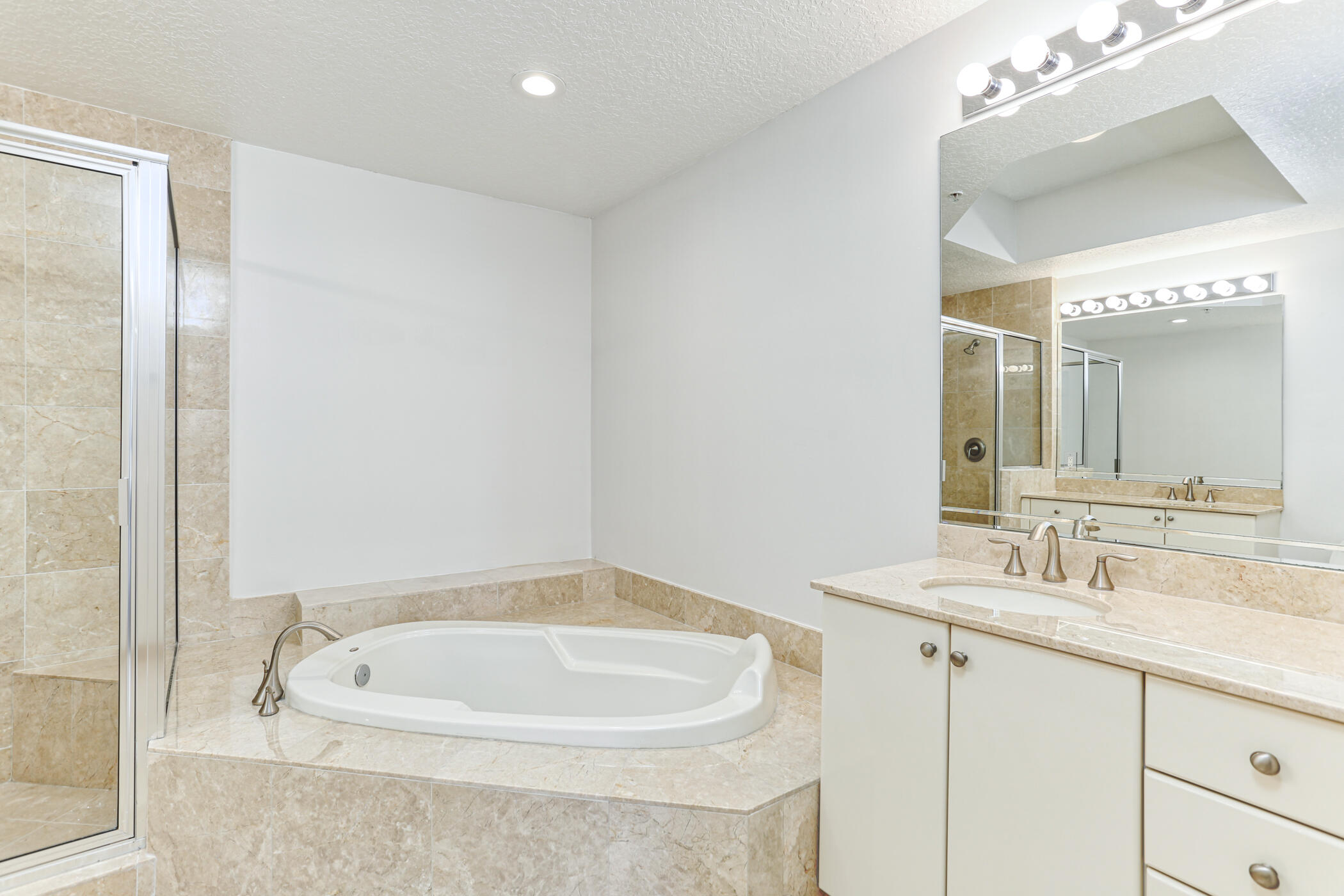 701 South Olive Avenue, Unit 603 West Palm Beach, FL 33401 - Photo 11 of 23 a bathroom with a bathtub a sink and a mirror