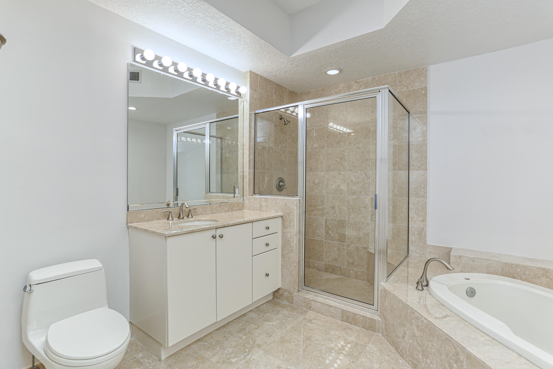 701 South Olive Avenue, Unit 603 West Palm Beach, FL 33401 - Photo 12 of 23 a bathroom with a granite countertop sink toilet and shower