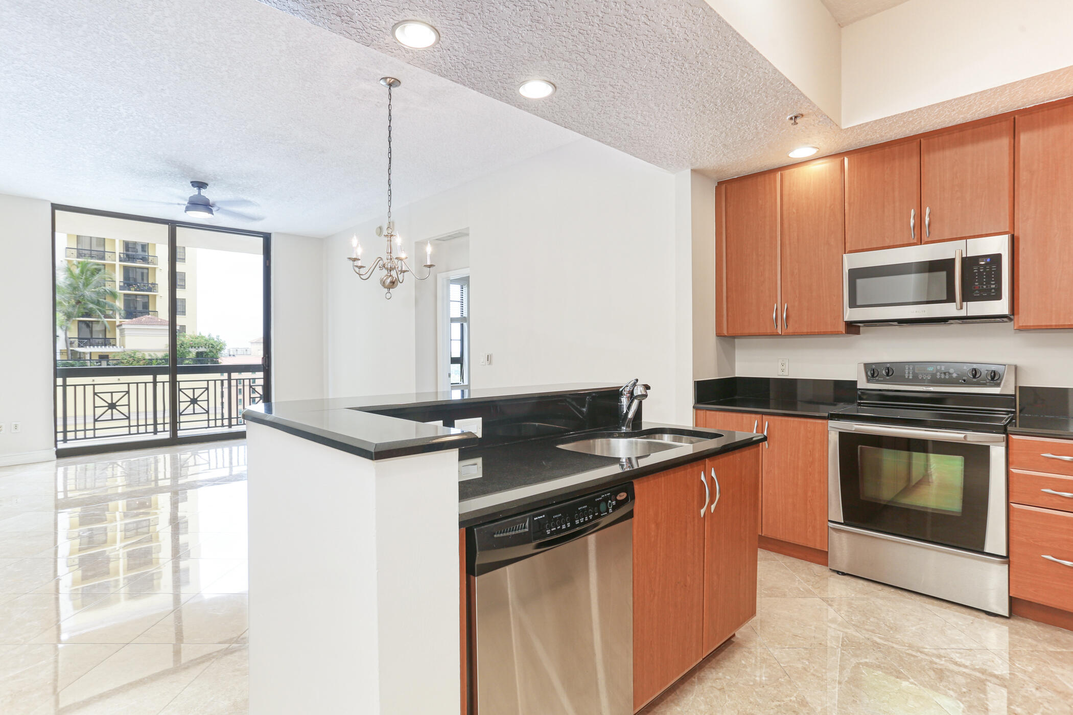 701 South Olive Avenue, Unit 603 West Palm Beach, FL 33401 - Photo 23 of 23 a kitchen with stainless steel appliances granite countertop a stove a sink and a microwave