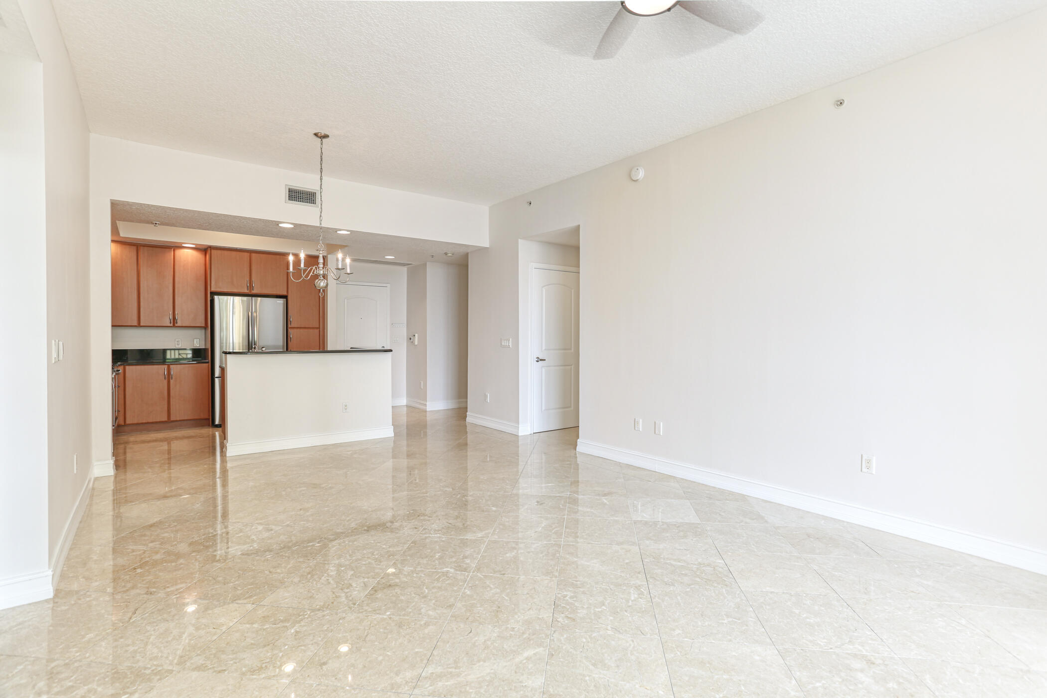 701 South Olive Avenue, Unit 603 West Palm Beach, FL 33401 - Photo 9 of 23 a view of a kitchen with a refrigerator and a sink
