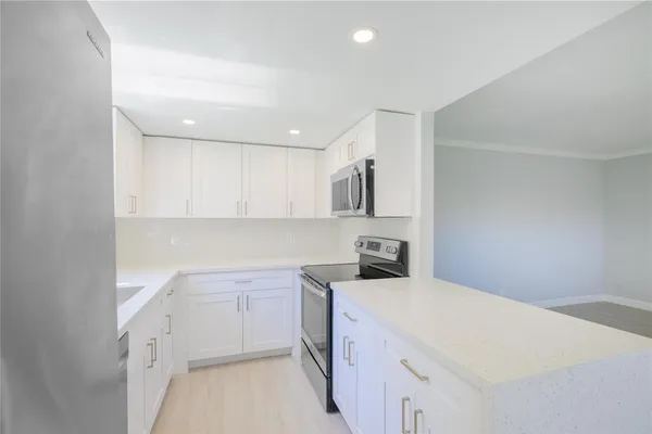a kitchen with a sink stove and cabinets